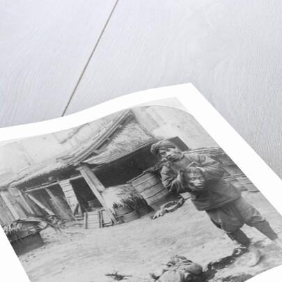 The grim executioner taking the labled head to exhibit a warning by Underwood & Underwood