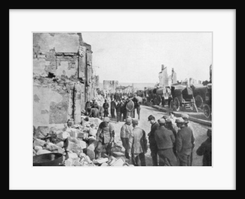 Captive German prisoners removing debris from the streets of Clermont-en-Argonne, France by Anonymous