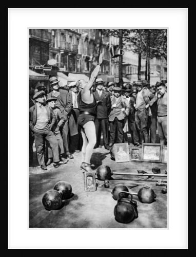 Strongman juggling with weights, Paris by Ernest Flammarion