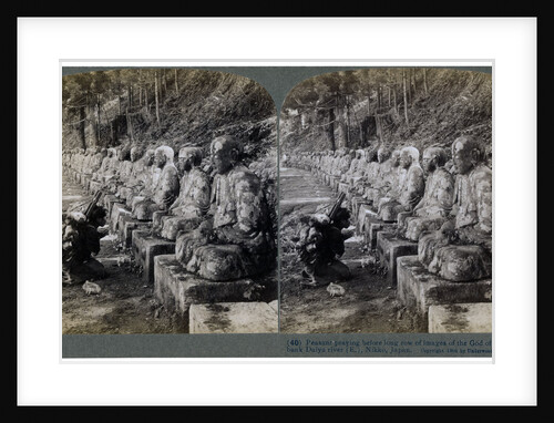 Peasant praying before a row of statues of the God of Light, Daiya river, Nikko, Japan by Underwood & Underwood