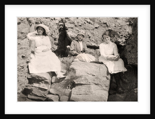 Three women relaxing on rocks by Anonymous