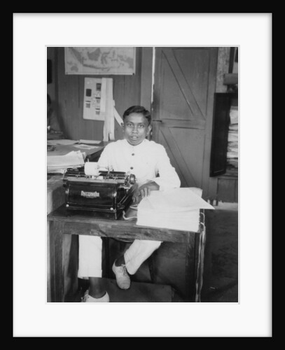 A young man sitting at a typewriter, Indonesia by Anonymous