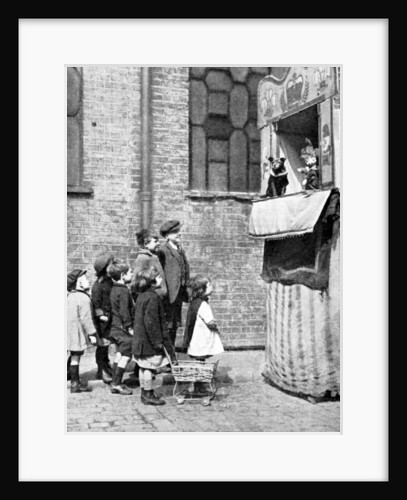 Children watching a Punch and Judy show in a London street by Donald McLeish