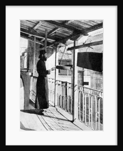 Monk sounding the call to prayer on a gong, Greece by Nomias