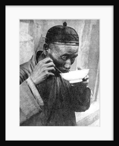 A man eating, Mukden (Shenyang), China by Wide World Photos