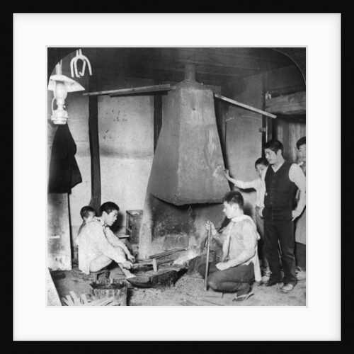 A Japanese blacksmith at his forge, Yokohama, Japan by Underwood & Underwood