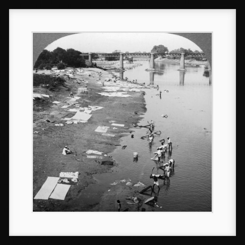 Dbobies washing clothes in the Goomti River, near Lucknow, India by Underwood & Underwood