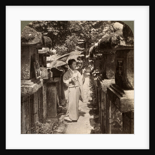 A woman Shinto devotee counting the stone lanterns, Kasuga Shrine, Nara, Japan by Underwood & Underwood