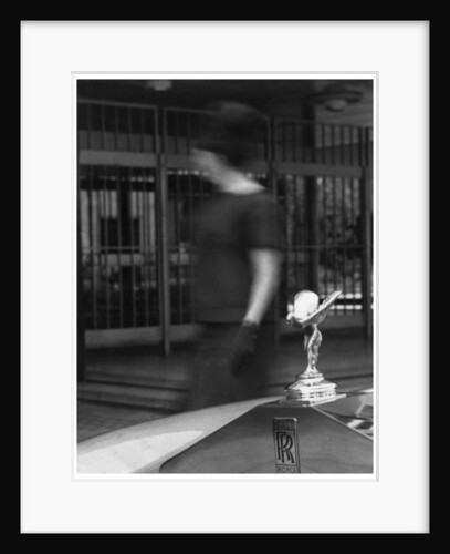 Woman walking past a Rolls-Royce by Anonymous