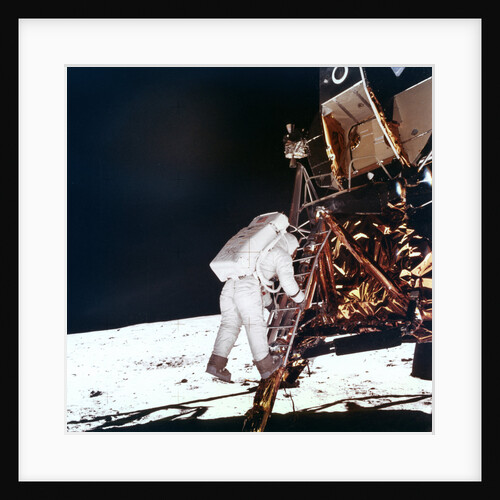 Edwin Buzz Aldrin descends the steps of the Lunar Module ladder to walk on the Moon by NASA