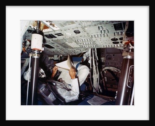 An astronaut inside a NASA Command Module by NASA