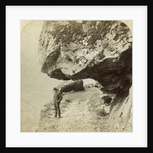 Man on a cliff overlooking Naeroyfjord, Sogne, Norway by Bert Underwood