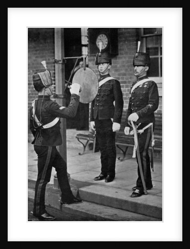 Striking the gong at the main gate of the Aldershot cavalry barracks, Hampshire by Gregory & Co