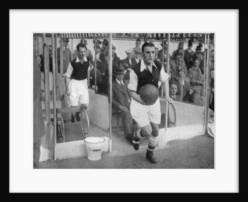 Arsenal FC captain Eddie Hapgood runs onto the pitch at Highbury, London by Barratt's Photo Press Ltd