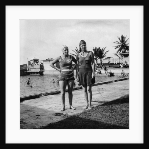 Two women in swimsuits beside a swimming pool, Balboa, Panama by Anonymous