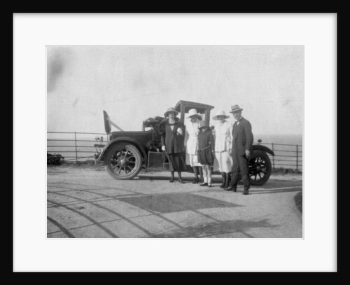 A group of people in front of their car at the seaside by Anonymous