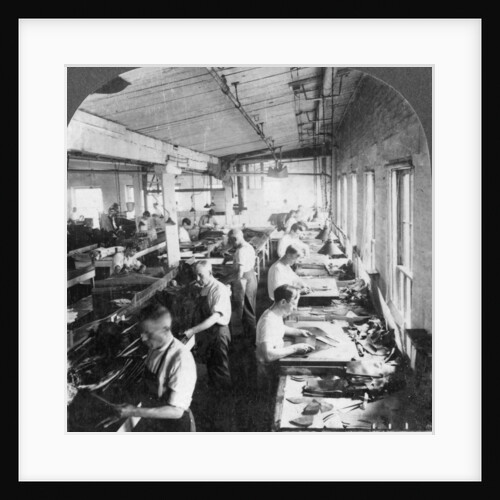 Workers cutting leather for shoes in a factory, Lynn, Massachusetts, USA by Keystone View Company