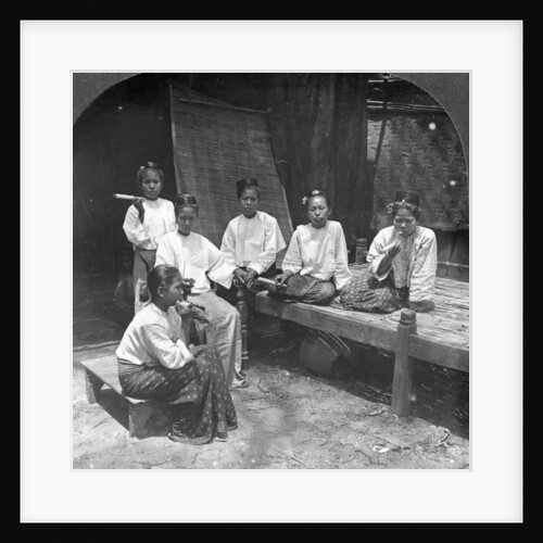 Burmese women smoking outside their home, Mandalay, Burma by Stereo Travel Co