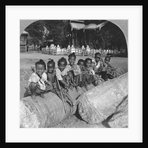 Burmese children sitting on a palm log, Burma by Stereo Travel Co