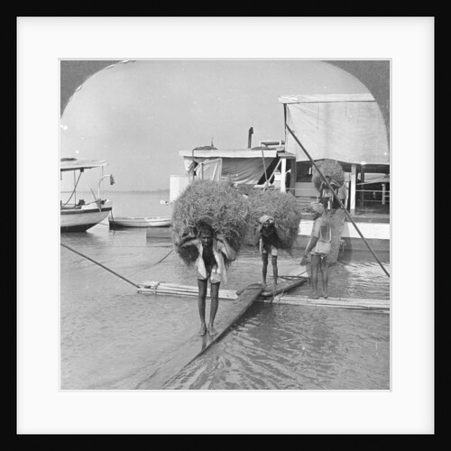 Unloading a vessel on the Irrawaddy River, Burma by Stereo Travel Co