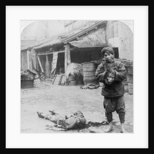 The grim executioner taking the labled head to exhibit a warning by Underwood & Underwood