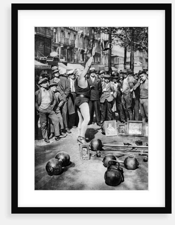Strongman juggling with weights, Paris by Ernest Flammarion
