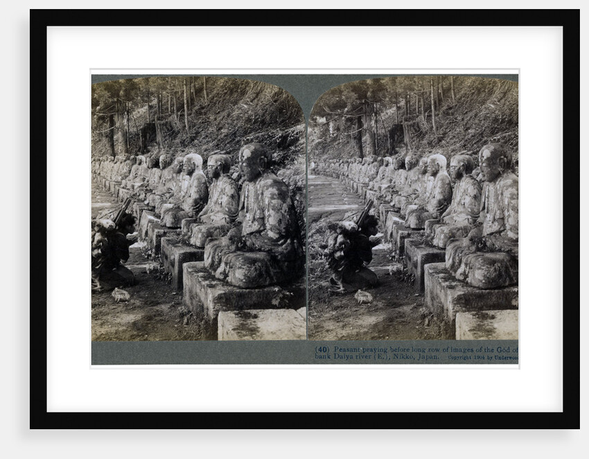 Peasant praying before a row of statues of the God of Light, Daiya river, Nikko, Japan by Underwood & Underwood