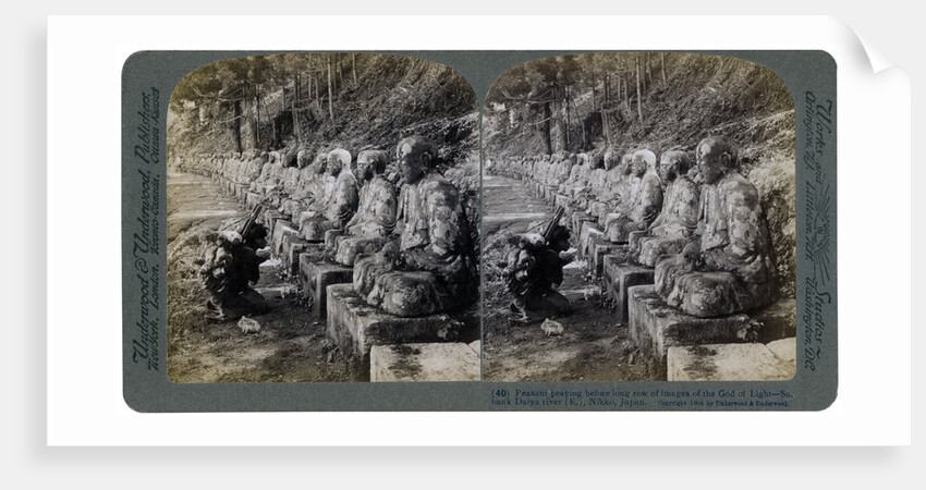Peasant praying before a row of statues of the God of Light, Daiya river, Nikko, Japan by Underwood & Underwood