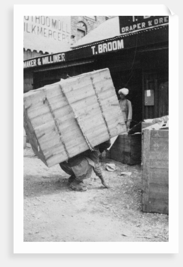 A porter lifting a large load, Chakrata, India by Anonymous