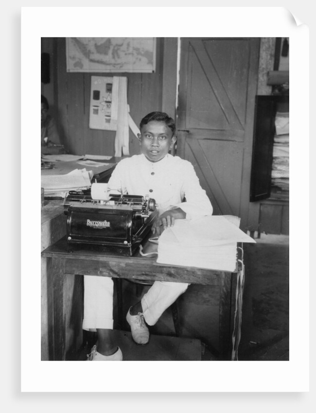 A young man sitting at a typewriter, Indonesia by Anonymous