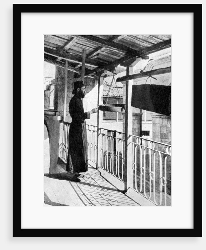 Monk sounding the call to prayer on a gong, Greece by Nomias