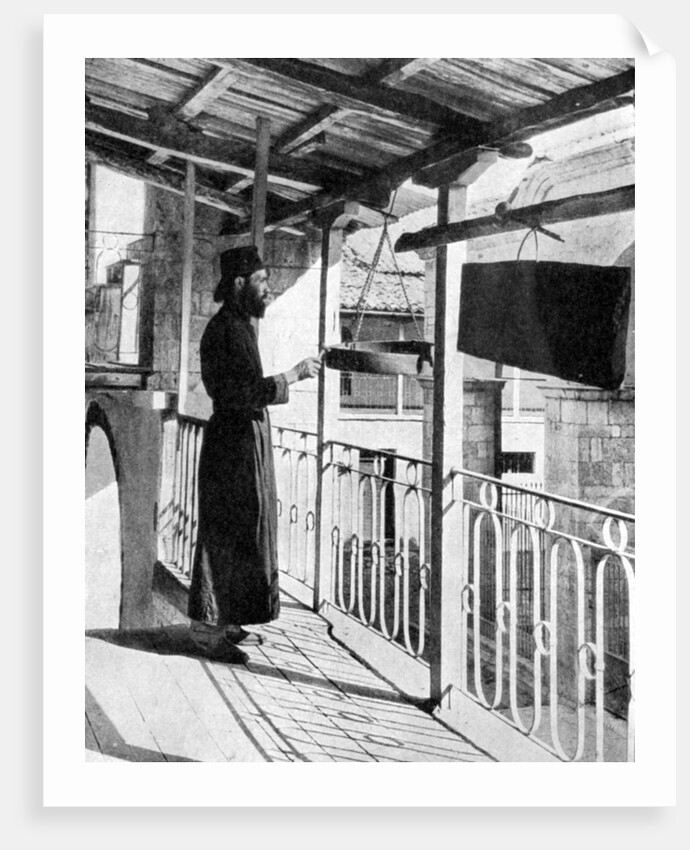 Monk sounding the call to prayer on a gong, Greece by Nomias