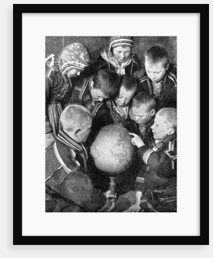 Lapp children looking at a globe by Anonymous