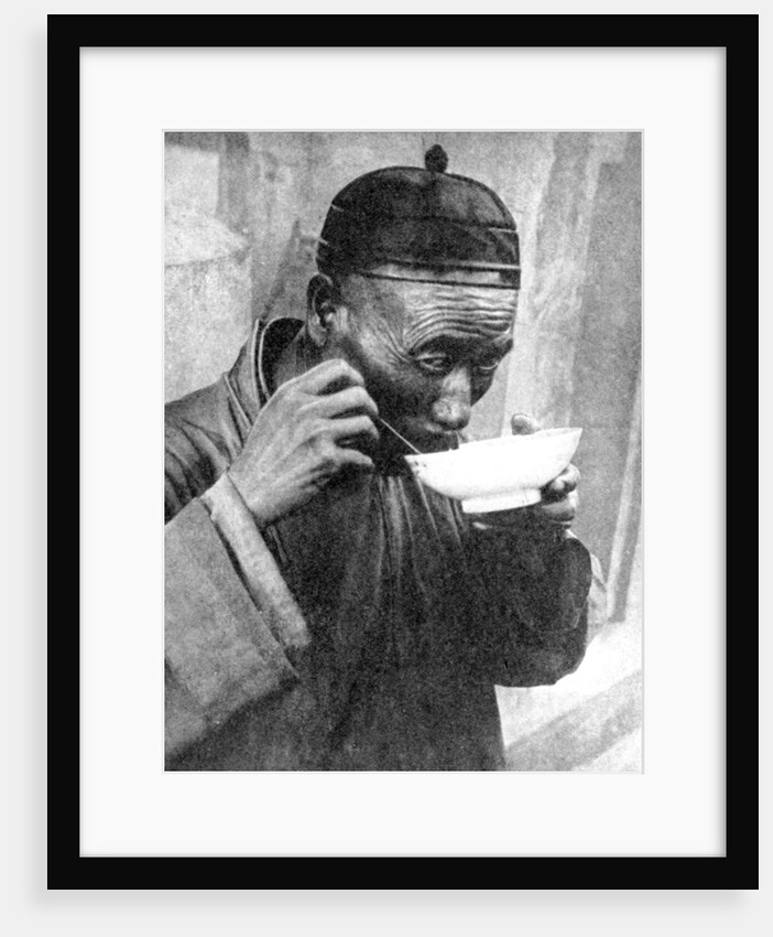 A man eating, Mukden (Shenyang), China by Wide World Photos