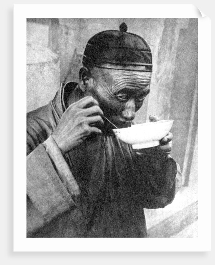 A man eating, Mukden (Shenyang), China by Wide World Photos