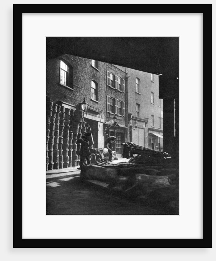 Fruit baskets piled against houses at Borough Market, London by Whiffin