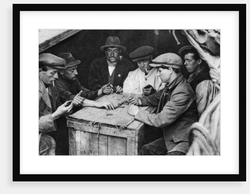 A bargee and his mates play dominoes in the hold of a canal boat by Anonymous