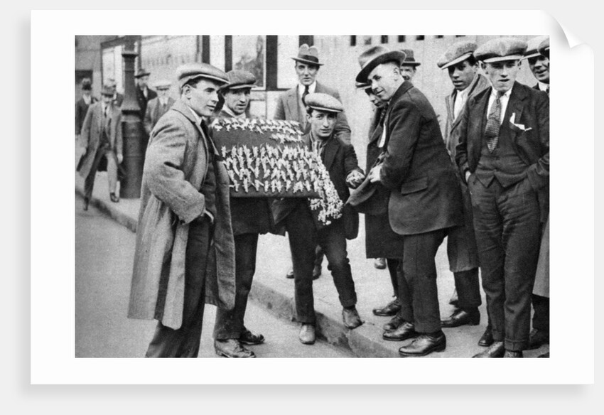 Street hawker selling football favours in King's Cross, London by Anonymous