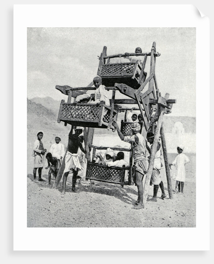 Arabian children enjoying a 'big-wheel' by Anonymous