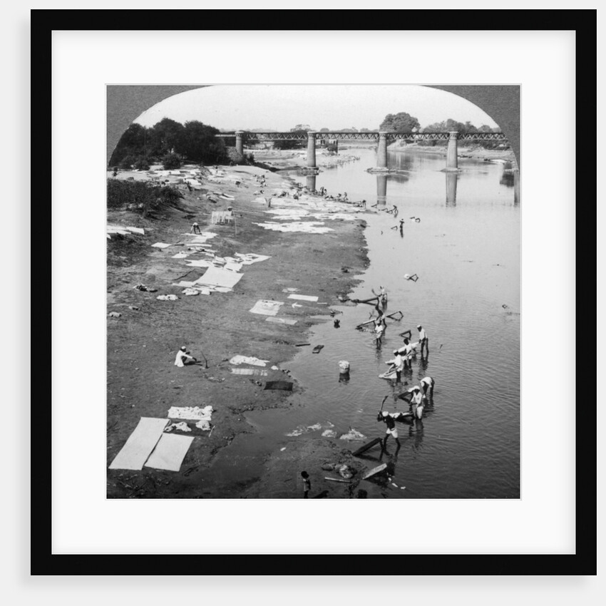 Dbobies washing clothes in the Goomti River, near Lucknow, India by Underwood & Underwood