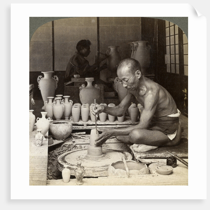 A potter and his wheel, fashioning a vase of Awata porcelain, Kinkosan works, Kyoto, Japan by Underwood & Underwood