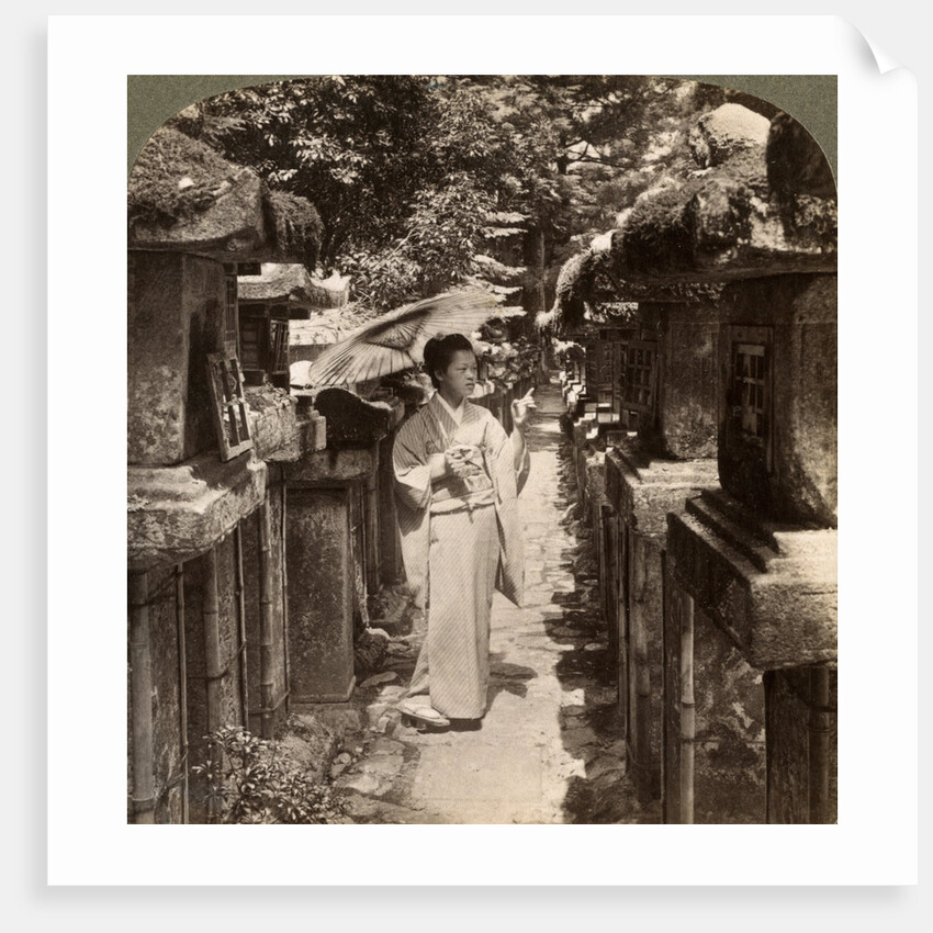 A woman Shinto devotee counting the stone lanterns, Kasuga Shrine, Nara, Japan by Underwood & Underwood