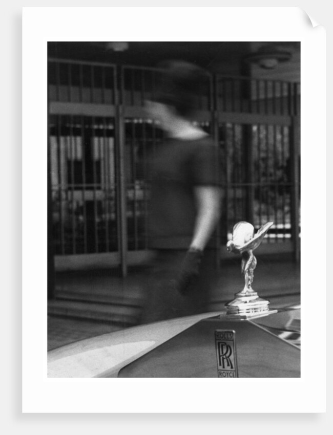 Woman walking past a Rolls-Royce by Anonymous