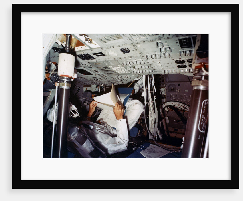 An astronaut inside a NASA Command Module by NASA