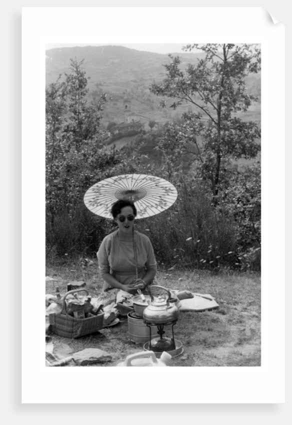 Woman under a parasol having a picnic by Anonymous
