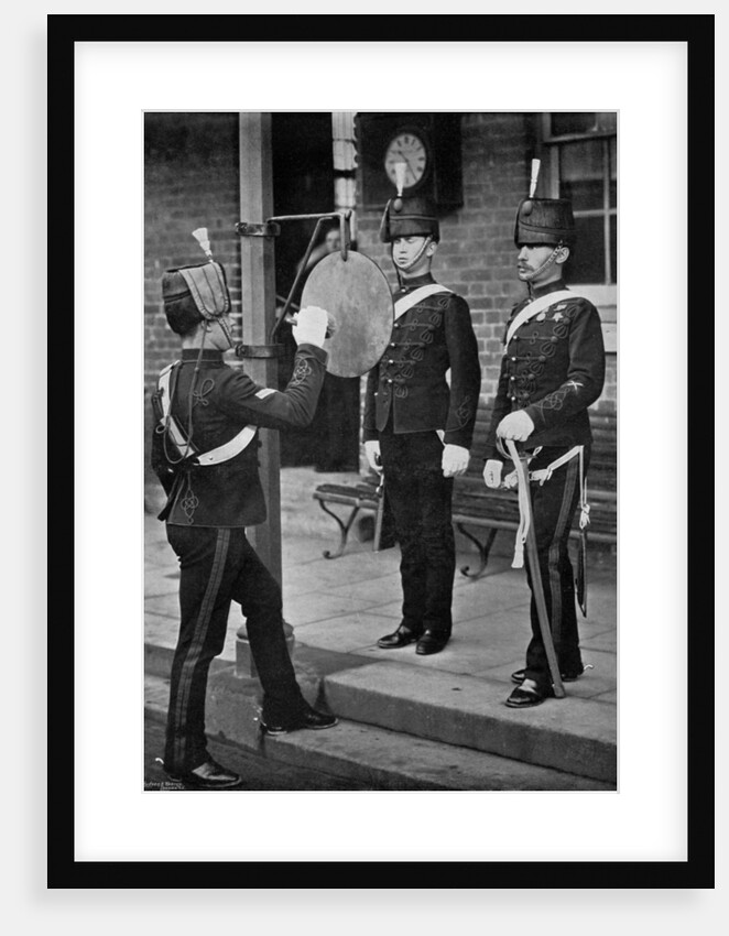 Striking the gong at the main gate of the Aldershot cavalry barracks, Hampshire by Gregory & Co