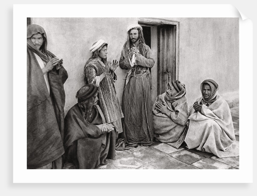 A mullah teaching a prayer to a young man, Iraq by A Kerim