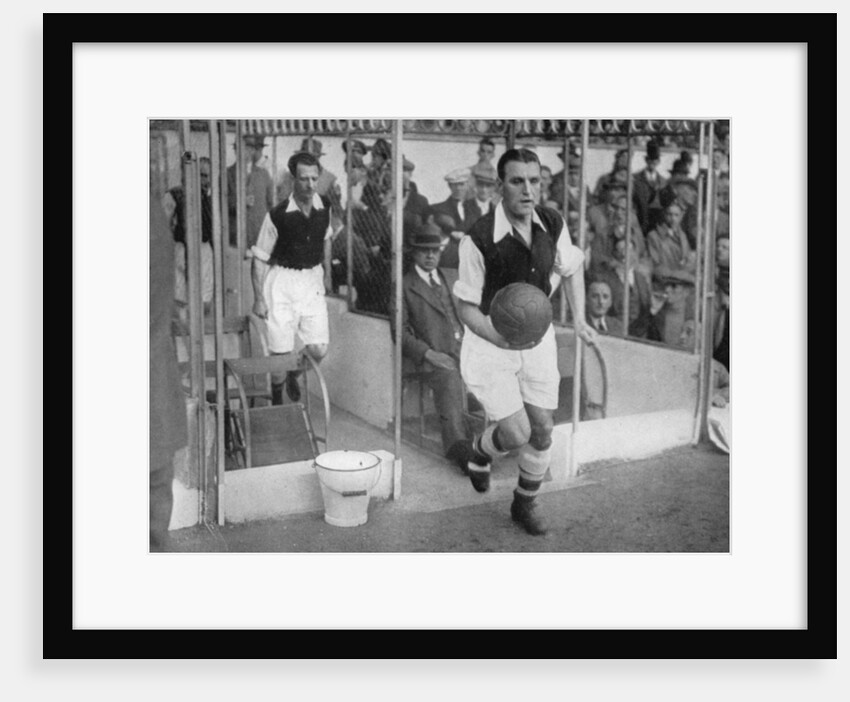 Arsenal FC captain Eddie Hapgood runs onto the pitch at Highbury, London by Barratt's Photo Press Ltd