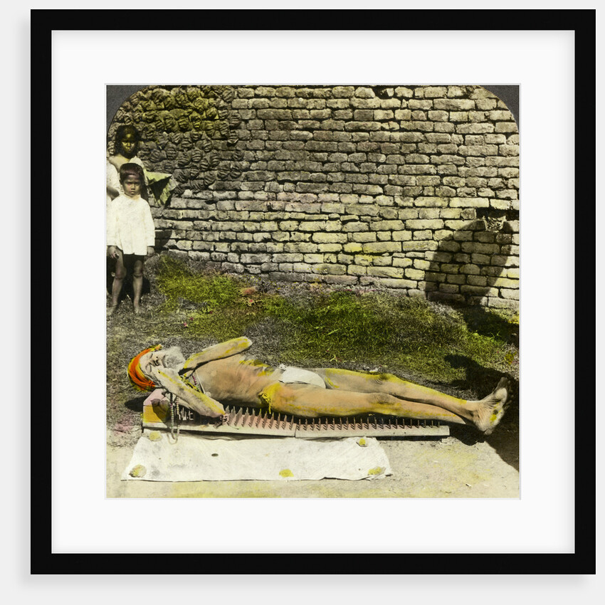 Hindu devotee on a bed of nails near the shrine of Kali, Calcutta, India by Underwood & Underwood