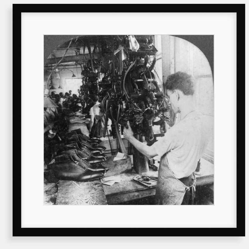 Lasting machine shaping shoes in shoe factory, Lynn, Massachusetts, USA by Keystone View Company